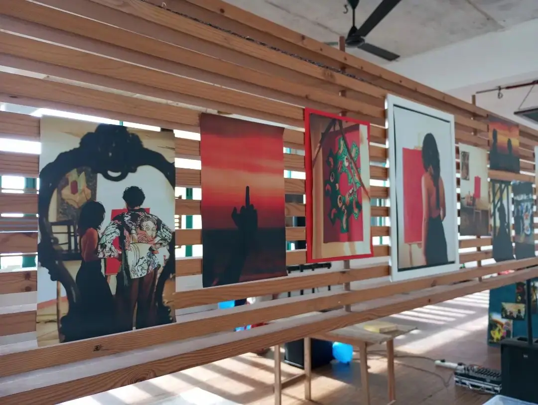 Photographs hung on a timber slat wall at A Second Layer