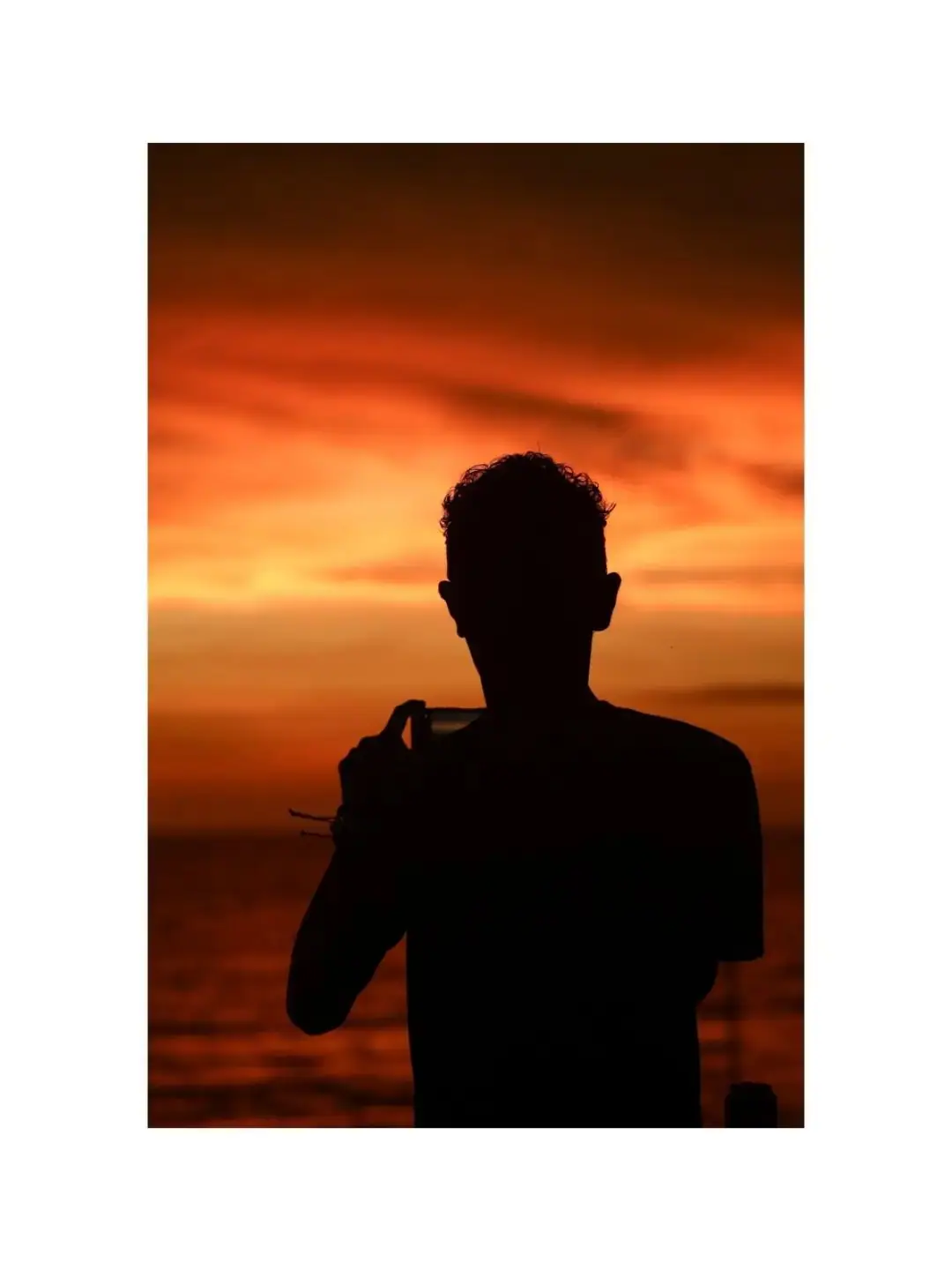 A silhouette photographing the sunset