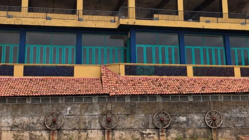 Terracotta roof and teal balconies of the building