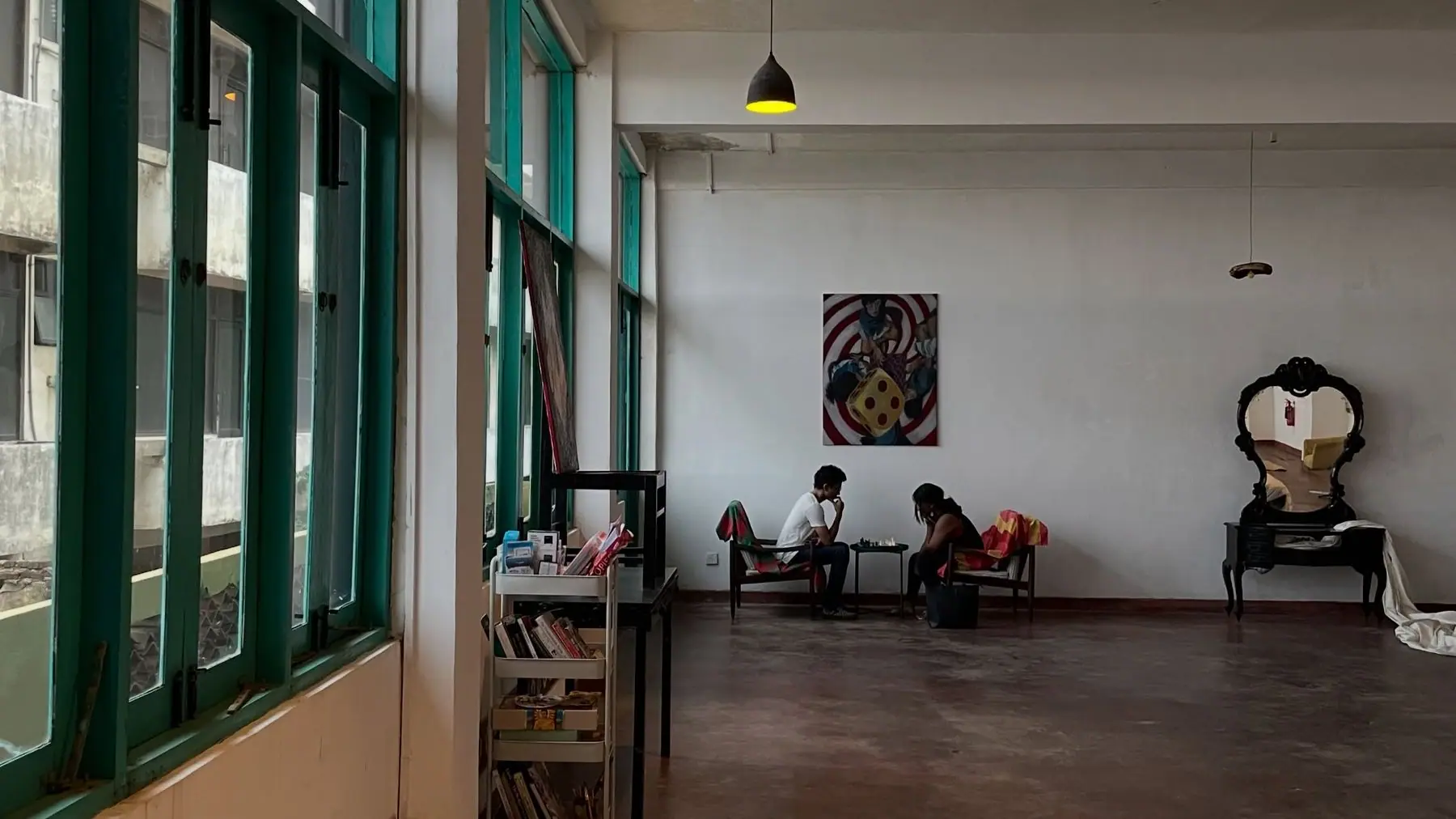 People relaxing in the gallery under the windows