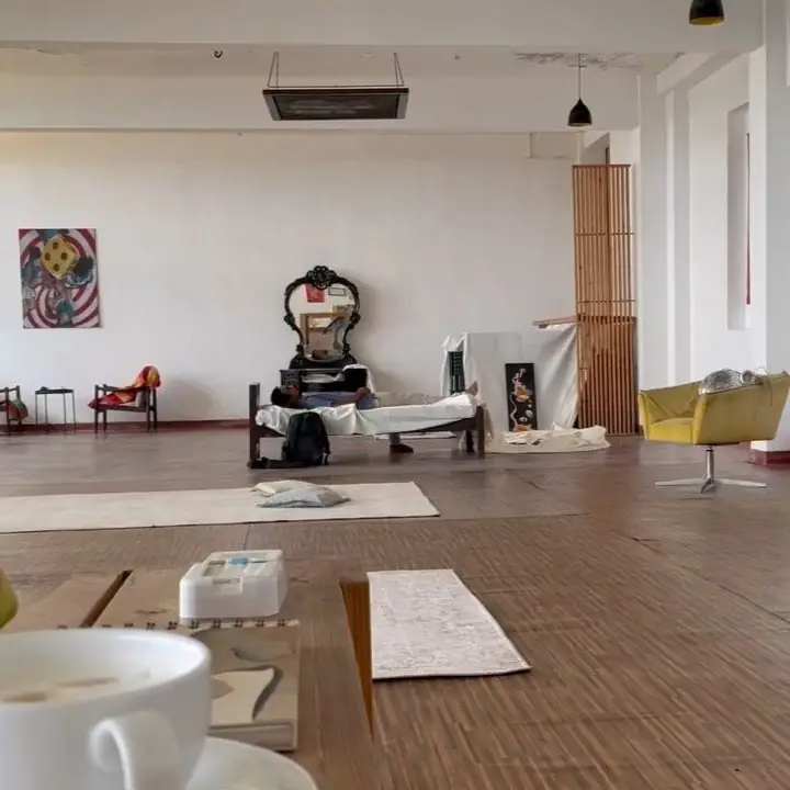 The gallery room set with mats, chairs and a painting