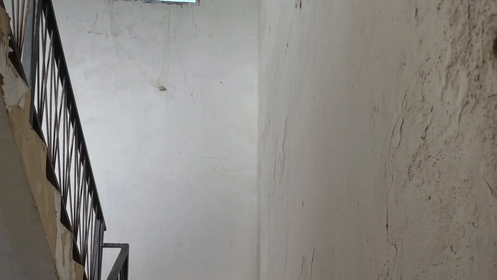 A stairwell wall lit from a high window